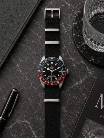 Black fabric NATO strap from vild Hamburg, mounted on a Tudor Black Bay GMT Ref. M79830RB-0003 and shown decoratively from above.