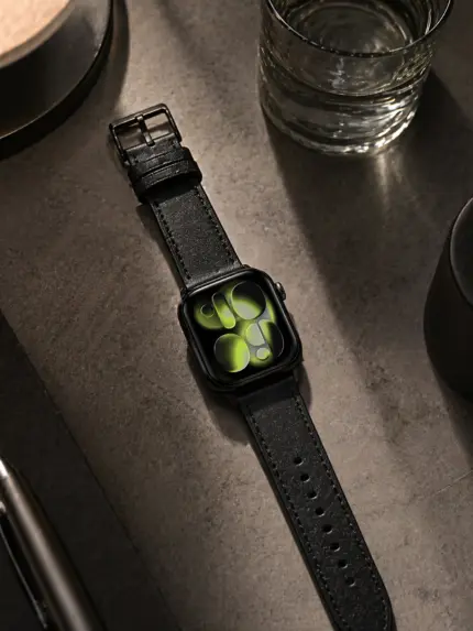 Apple Watch Lederarmband schwarz von vild Hamburg, an der Uhr montiert und von oben mit passender Dekoration fotografiert