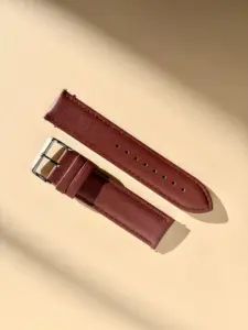 reddish-brown leather watch strap in sunlight against a colored background by vild Hamburg