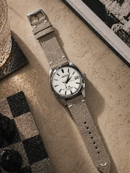 Vintage grey and beige suede strap from vild Hamburg, mounted on a Grand Seiko Heritage Collection and shown decoratively from above.