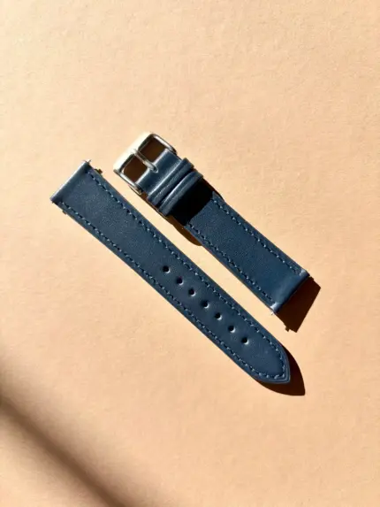 dark blue leather watch strap in sunlight against a colored background by vild Hamburg