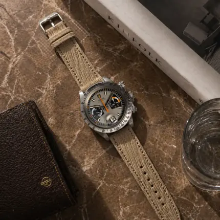 Beige canvas watch strap by vild Hamburg, mounted on a Tudor Oysterdate Chronograph Monte Carlo and photographed from above with decoration