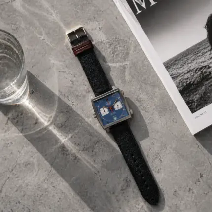 Dark blue canvas watch strap by vild Hamburg, mounted on a TAG Heuer Monaco Calibre 11 and shown decoratively from above.