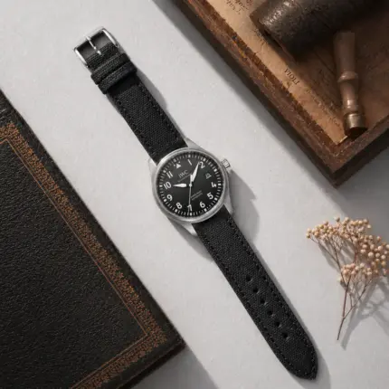 Canvas watch strap in black from vild Hamburg, mounted on an IWC Pilot's Watch Mark XVIII and photographed from above with decoration