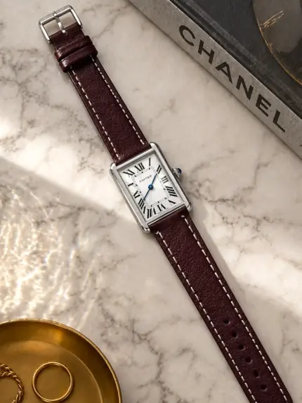 Berry leather bracelet by vild Hamburg, mounted on a Cartier Tank Solo and photographed decoratively from above.