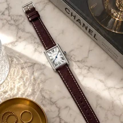 Berry leather bracelet by vild Hamburg, mounted on a Cartier Tank Solo and photographed decoratively from above.