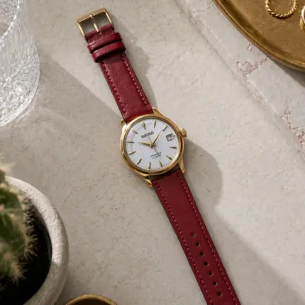 Dark red leather strap from vild Hamburg, mounted on a Seiko Presage Cocktail Time and photographed decoratively from above.