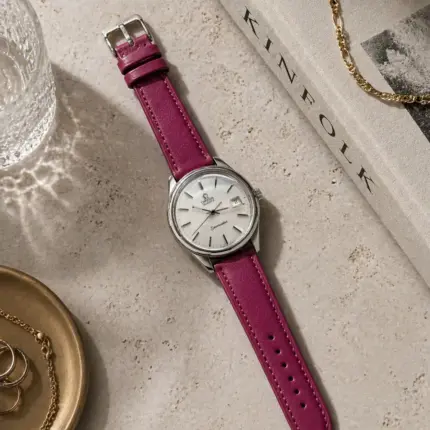 Fuchsia leather strap by vild Hamburg, mounted on an Omega Seamaster Vintage and shown from above with decoration