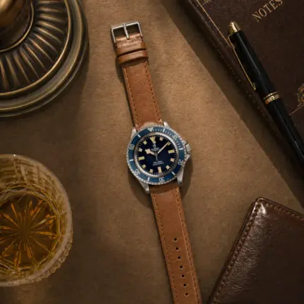 Caramel leather bracelet by vild Hamburg, mounted on a Tudor Submariner Snowflake and photographed decoratively from above.