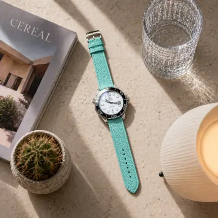 Turquoise leather strap from vild Hamburg, mounted on an Omega Seamaster Diver 300M and photographed from above with matching decoration