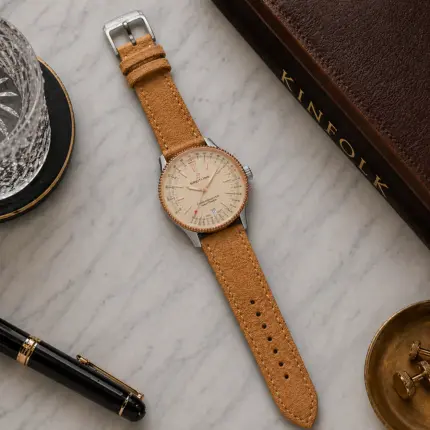 Amber suede strap by vild Hamburg, mounted on a Breitling Navitimer 1 and photographed decoratively from above.