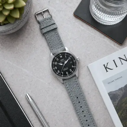 Suede strap, grey and blue, by vild Hamburg, mounted on an IWC Pilot's Watch Mark XVIII and photographed from above.