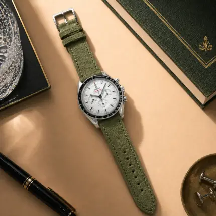 Green suede strap by vild Hamburg, mounted on an Omega Speedmaster Moonwatch and shown from above with decoration