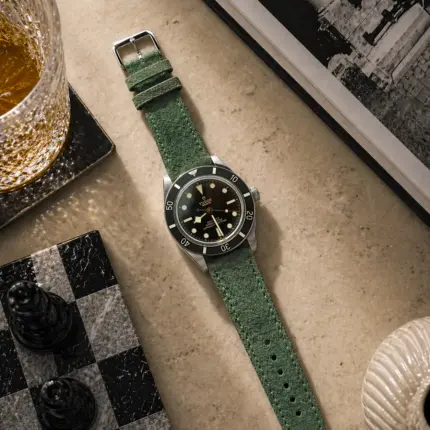 Green suede strap by vild Hamburg, mounted on a Tudor Black Bay 54 and photographed decoratively from above.