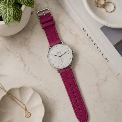 Pink suede bracelet by vild Hamburg, mounted on a NOMOS Metro watch and shown from above with decoration