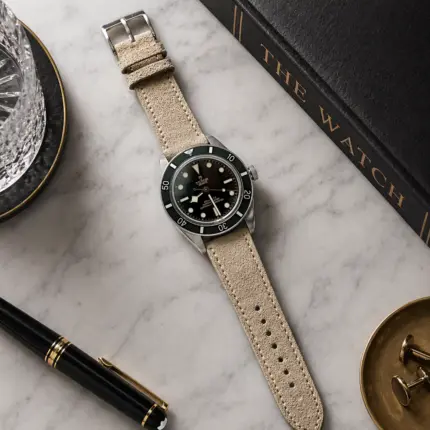 Sand suede strap by vild Hamburg, mounted on a Tudor Black Bay 54 and photographed decoratively from above.