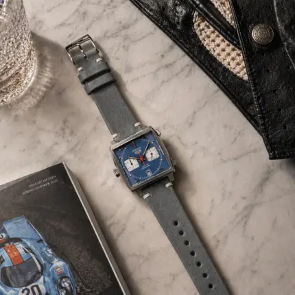 Vintage grey leather strap from vild Hamburg, mounted on a TAG Heuer Monaco and photographed from above with decoration