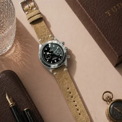 Vintage beige sand suede strap from vild Hamburg, mounted on a Tudor Black Bay Chrono and shown decoratively from above.