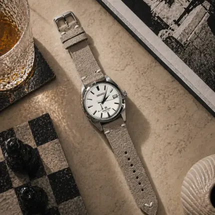 Vintage grey and beige suede strap from vild Hamburg, mounted on a Grand Seiko Heritage Collection and shown decoratively from above.