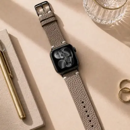 Apple Watch vintage leather strap, grey and beige, by vild Hamburg, mounted on the watch and shown from above with decoration.