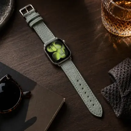 Apple Watch suede strap, blue-grey, by vild Hamburg, mounted on the watch and photographed from above with decoration.