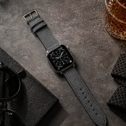 Apple Watch suede strap in dark grey by vild Hamburg, mounted on the watch and shown from above with matching decoration