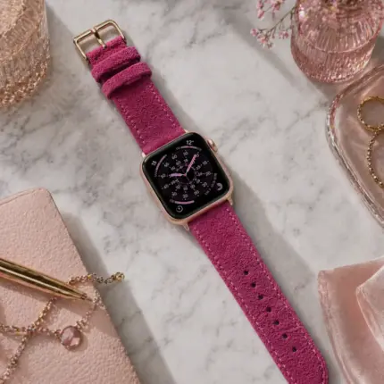 Apple Watch suede strap in pink by vild Hamburg, mounted on the watch and shown decoratively from above.