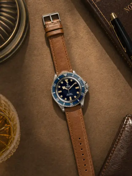 Caramel leather bracelet by vild Hamburg, mounted on a Tudor Submariner Snowflake and photographed decoratively from above.