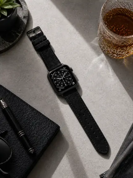 Apple Watch Wildleder Armband schwarz von vild Hamburg, an der Uhr montiert und von oben mit passender Dekoration gezeigt