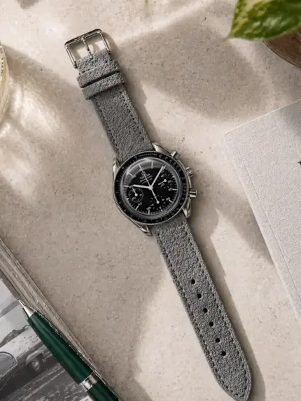 Grey suede strap by vild Hamburg, mounted on an Omega Speedmaster Reduced and shown from above with decoration