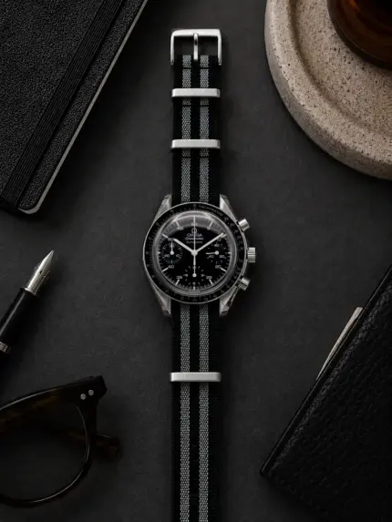 Bond grey and black premium NATO strap by vild Hamburg on an Omega Speedmaster Reduced 39 mm automatic, photographed from above with decoration