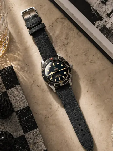 Dark grey suede strap by vild Hamburg, mounted on a Tudor Black Bay Fifty-Eight and shown decoratively from above.