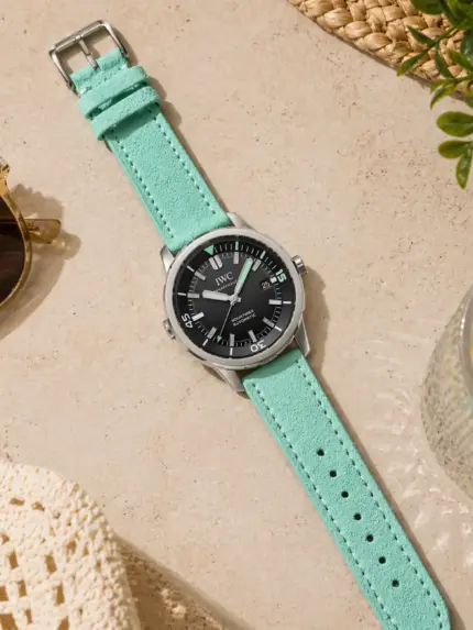 Turquoise suede strap from vild Hamburg, mounted on an IWC Aquatimer and photographed decoratively from above.