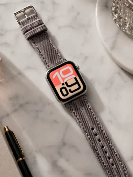 Apple Watch Canvas Band grey beige by vild Hamburg, mounted on the watch in a decorated top view.