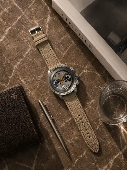 Beige canvas watch strap by vild Hamburg, mounted on a Tudor Oysterdate Chronograph Monte Carlo and photographed from above with decoration