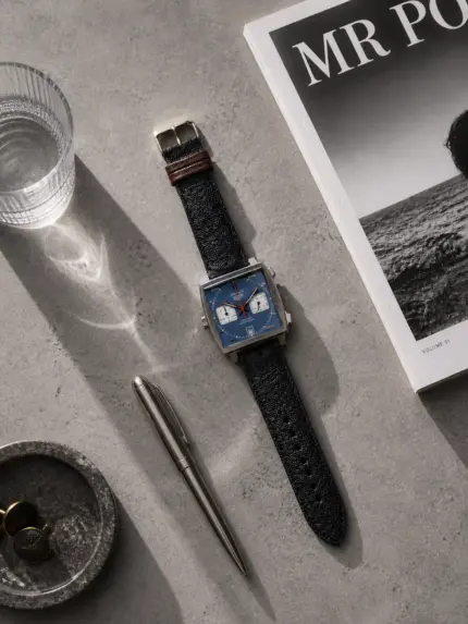 Dark blue canvas watch strap by vild Hamburg, mounted on a TAG Heuer Monaco Calibre 11 and shown decoratively from above.