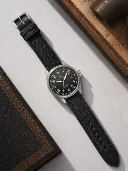 Canvas watch strap in black from vild Hamburg, mounted on an IWC Pilot's Watch Mark XVIII and photographed from above with decoration