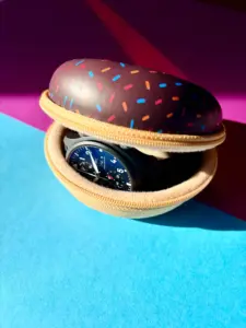 Watch case for 1 watch in a brown donut design with colorful sprinkles, containing an IWC Pilot's Watch.