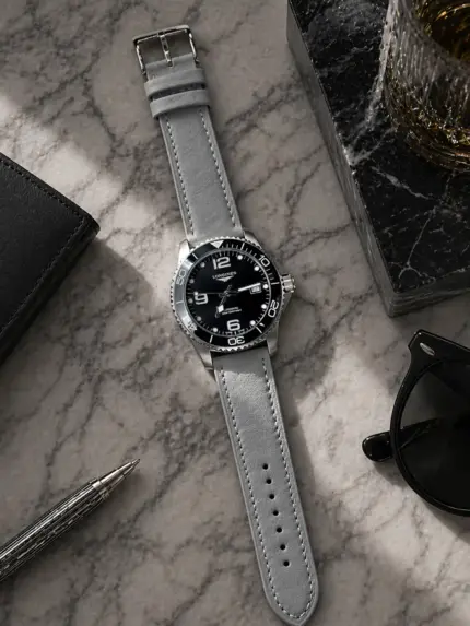 Grey leather strap by vild Hamburg, mounted on a Longines HydroConquest and shown from above with matching decoration