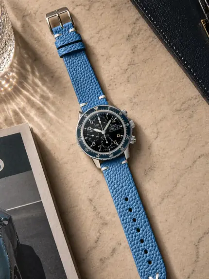 Vintage blue leather strap from vild Hamburg, mounted on a Sinn 103 and shown from above with decoration