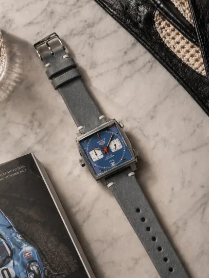 Vintage grey leather strap from vild Hamburg, mounted on a TAG Heuer Monaco and photographed from above with decoration