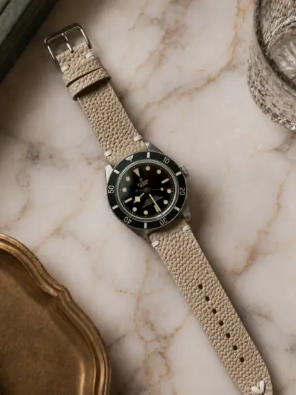 Vintage grey-brown leather strap from vild Hamburg, mounted on a Tudor Black Bay 54 and shown decoratively from above.
